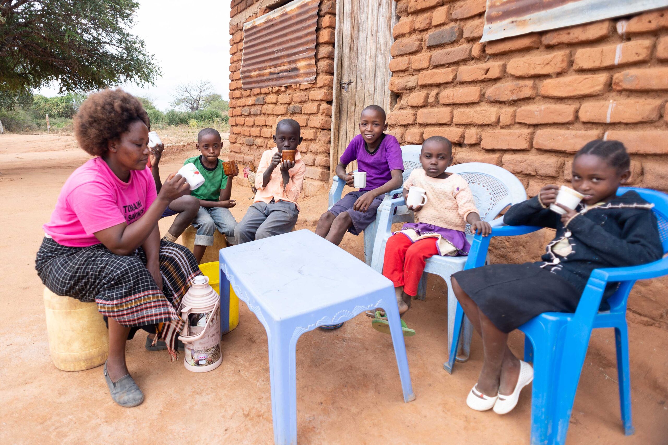 Scholastica eats with her children