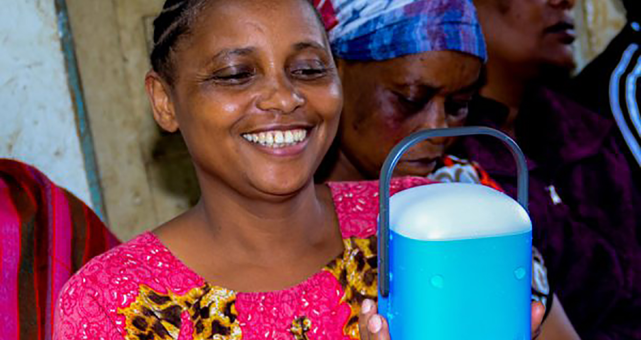 A woman with a solar light in Tanzania