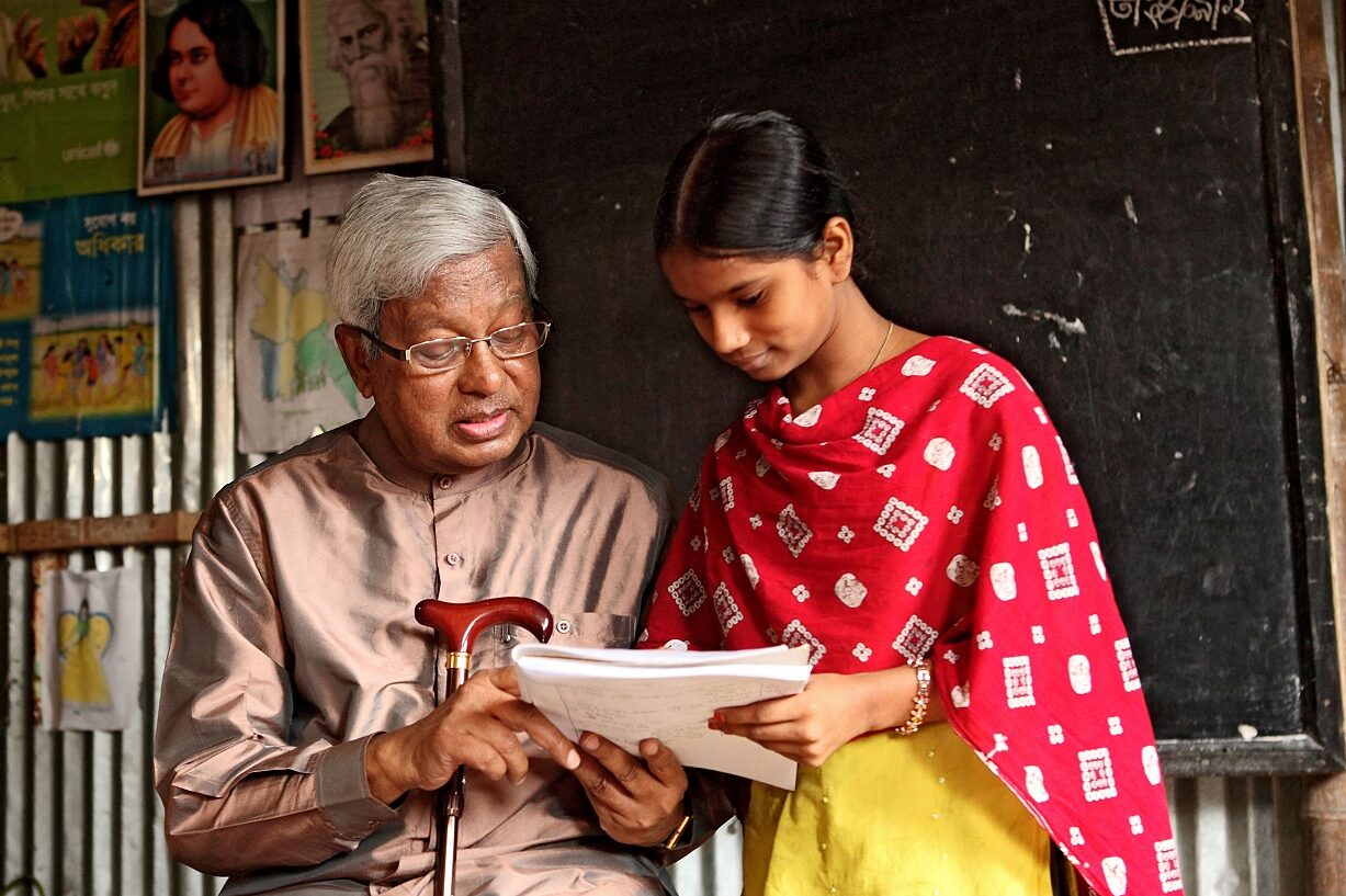 Sir Fazle with a girl reading