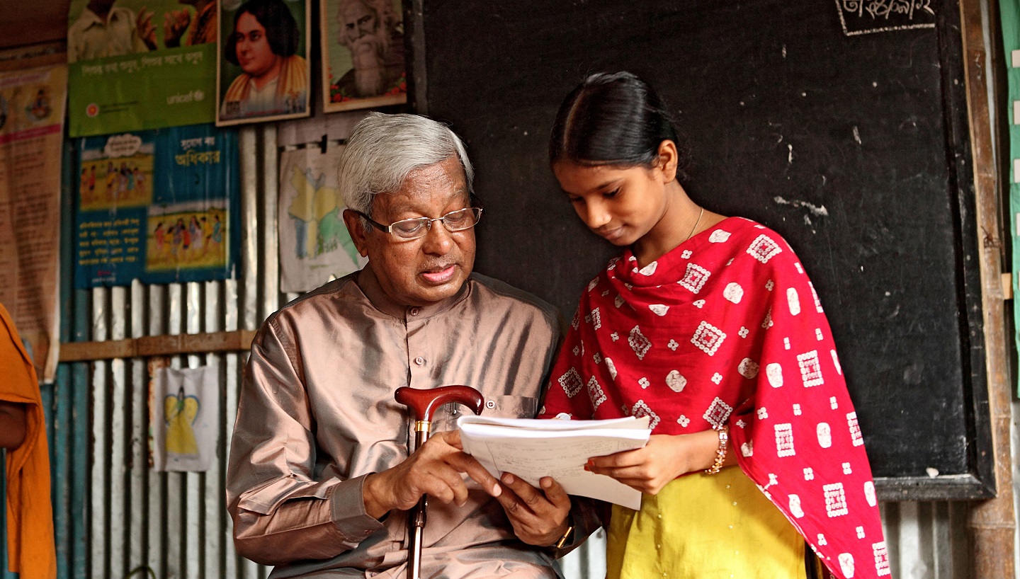 Sir Fazle with a girl reading