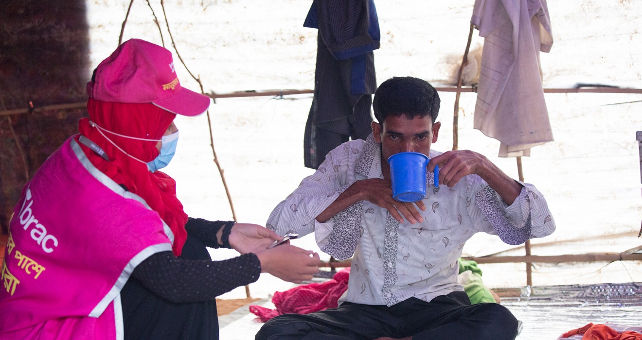 community health worker caring for a sick man.