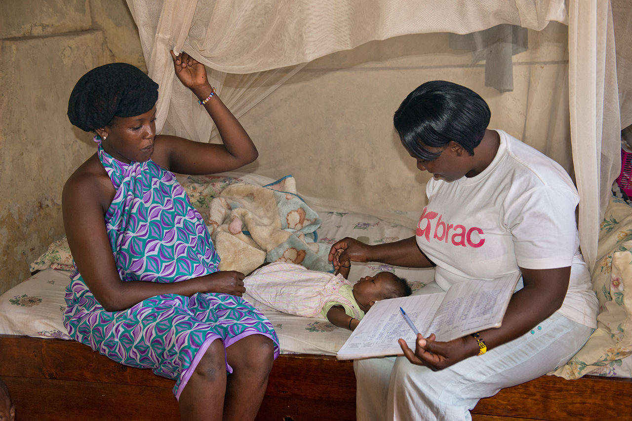 A community health worker cares for a mother and child in Uganda. Photo by Alison Wright.