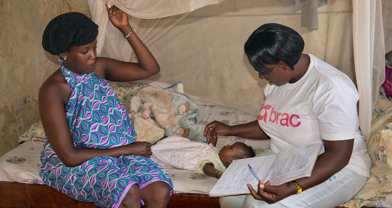 A community health worker cares for a mother and child in Uganda. Photo by Alison Wright.