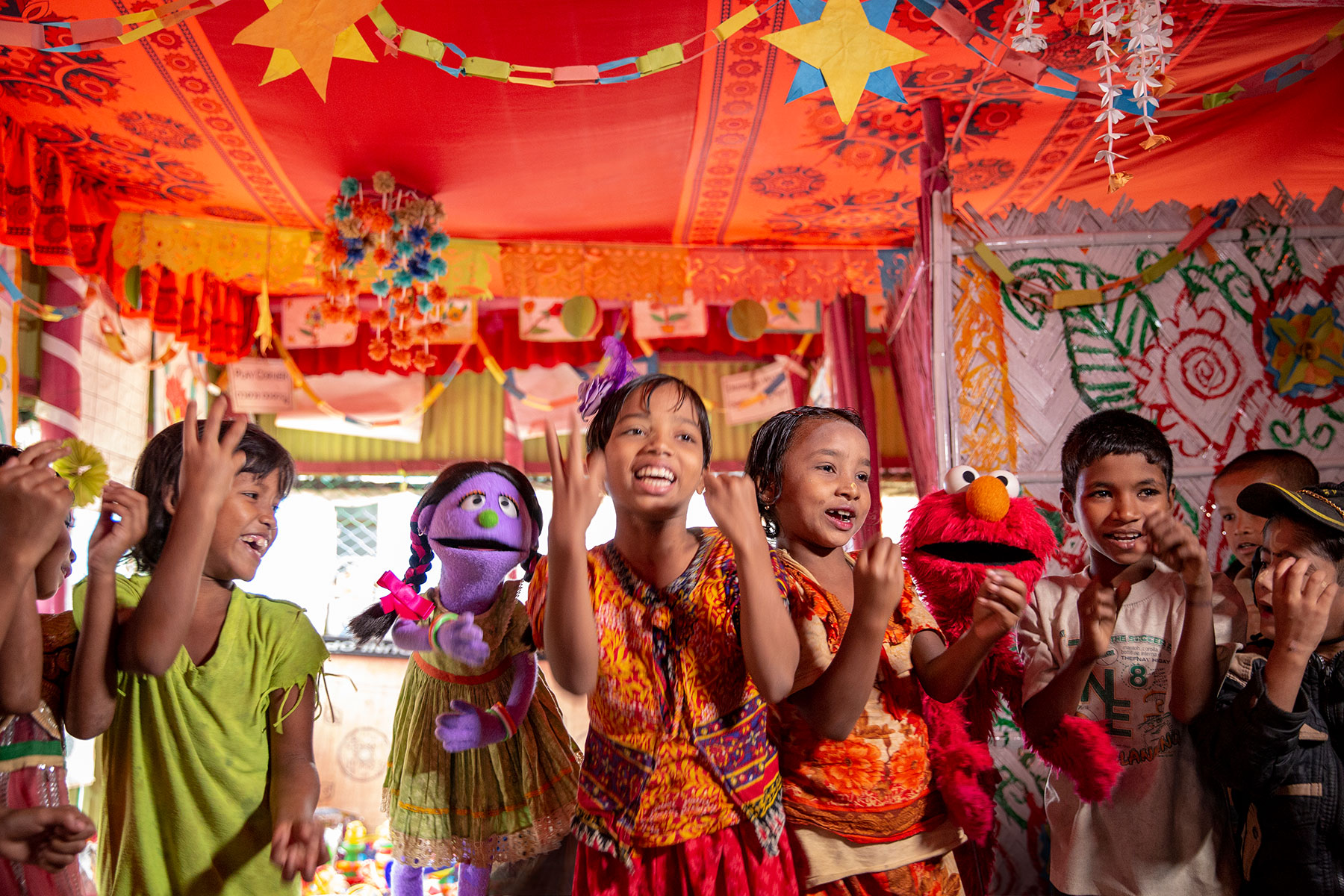 Rohingya children play with muppets in a BRAC Humanitarian Play Lab. Photo by Ryan Donnell for Sesame Workshop.