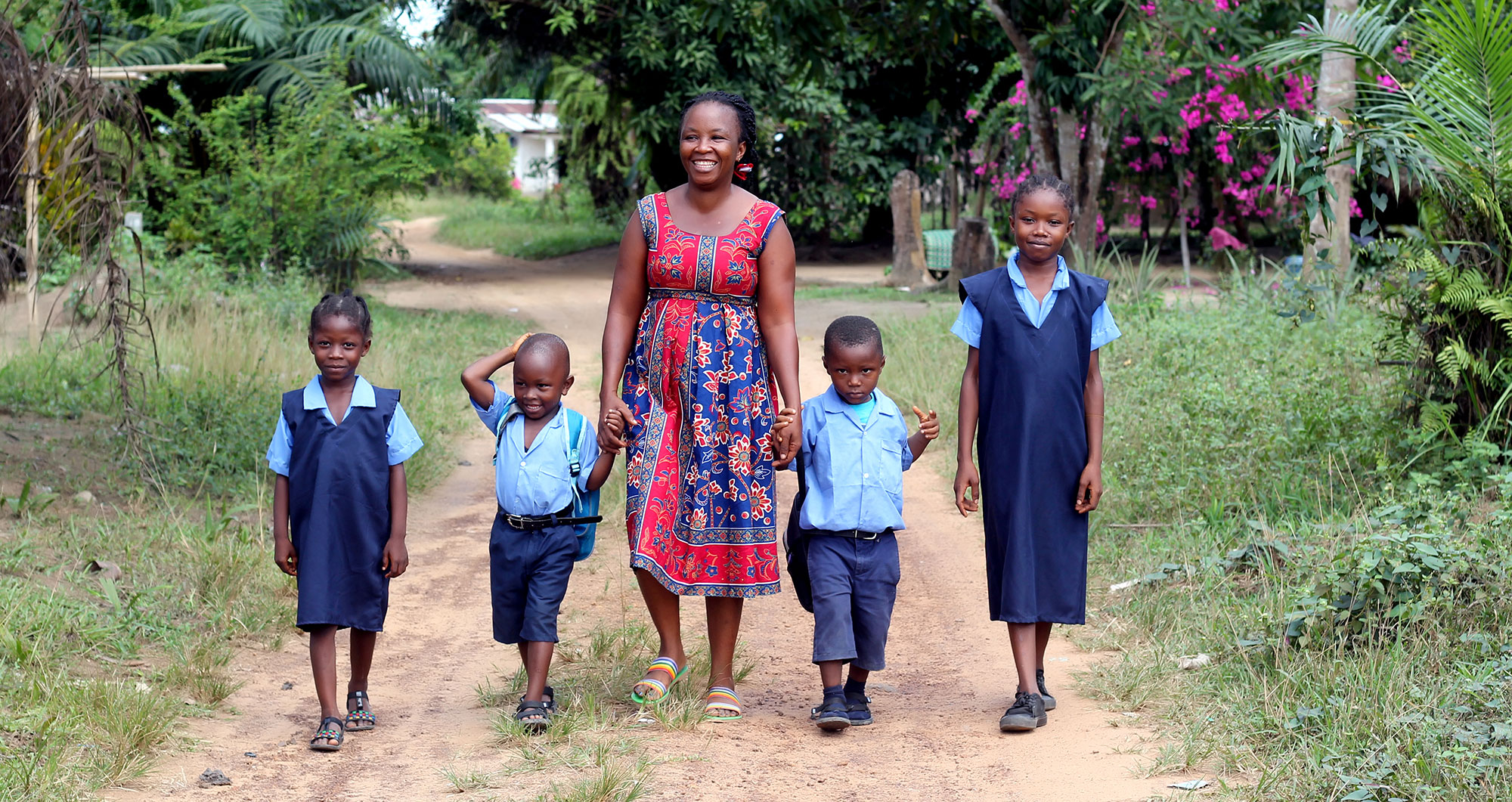 A Graduation participant with her children in Liberia