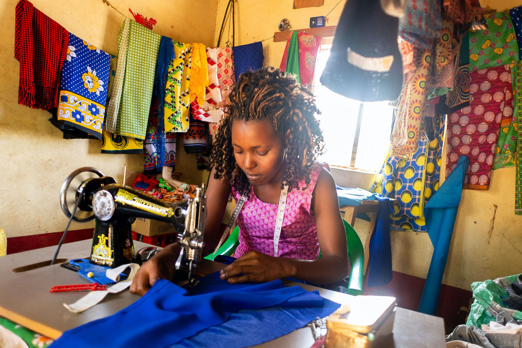 A woman in BRAC's Graduation program sews clothes