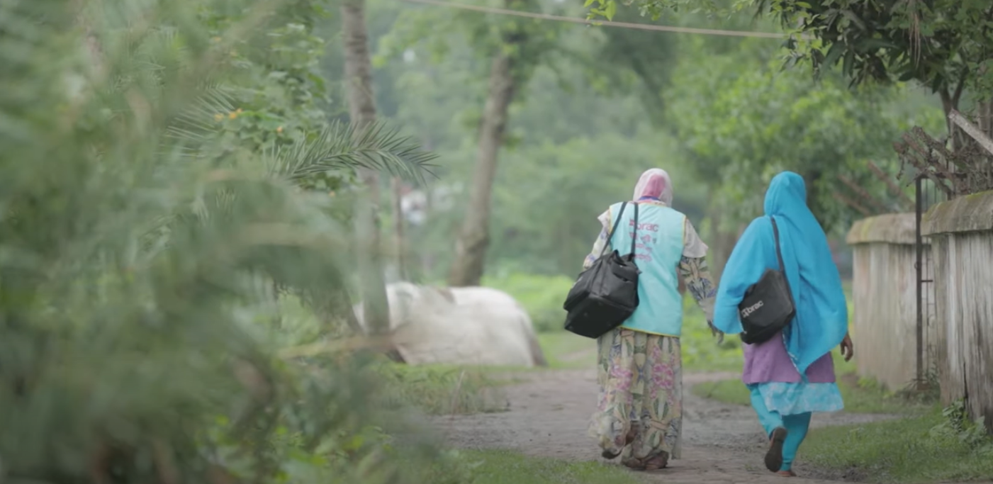 Community health workers walking through the village.