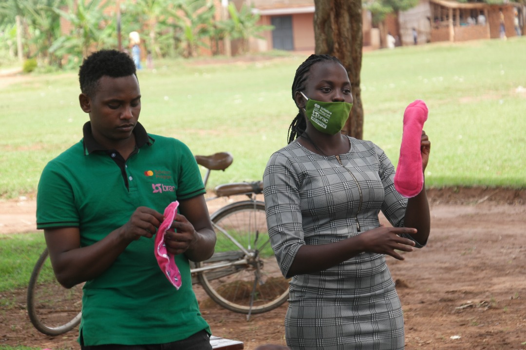 Cynthia distributes reusable sanitary pads to girls in Uganda.