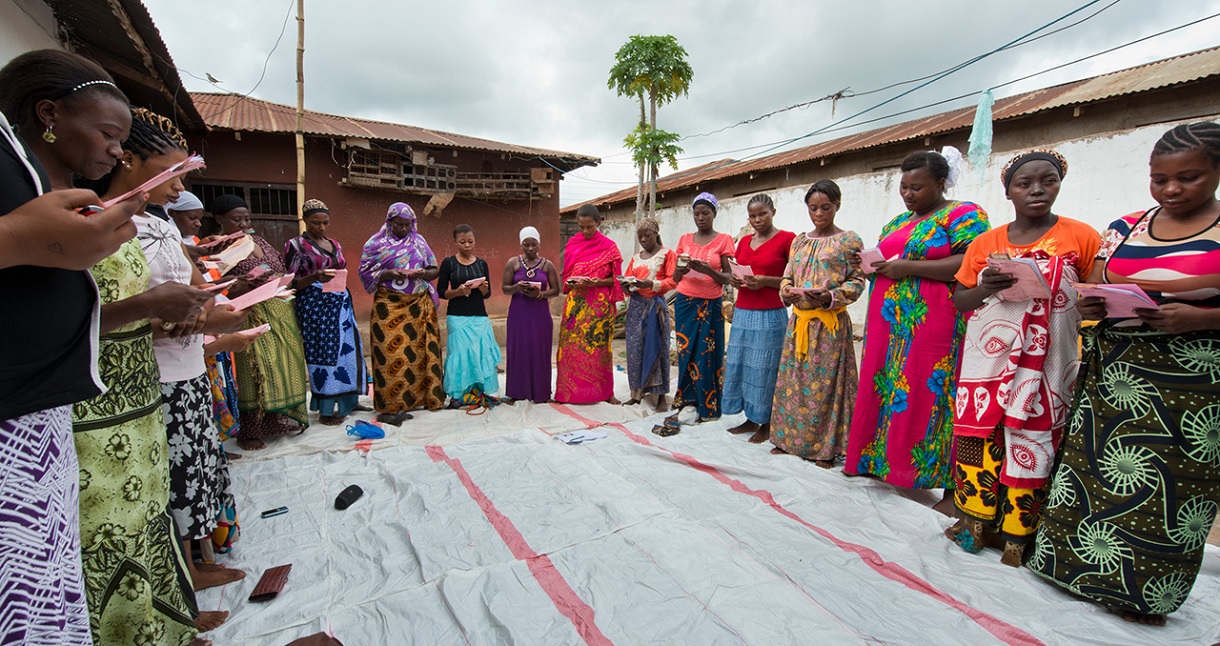 A group of women review learning materials