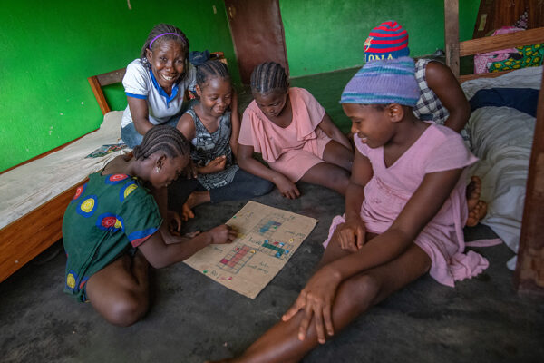 Selena reads with a group of girls at the orphanage she runs. Photo by Alison Wright.