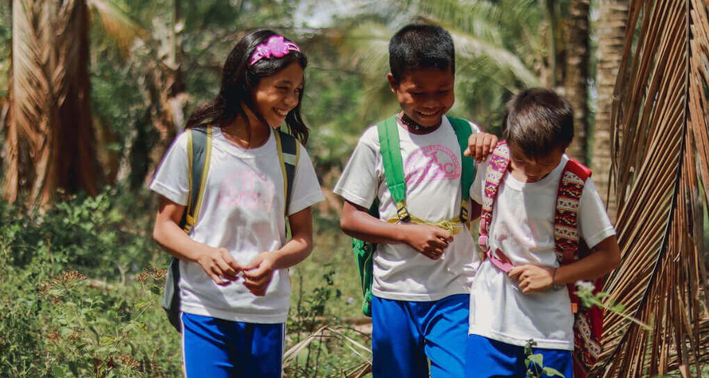 Children laugh as they walk to school in Bangladesh