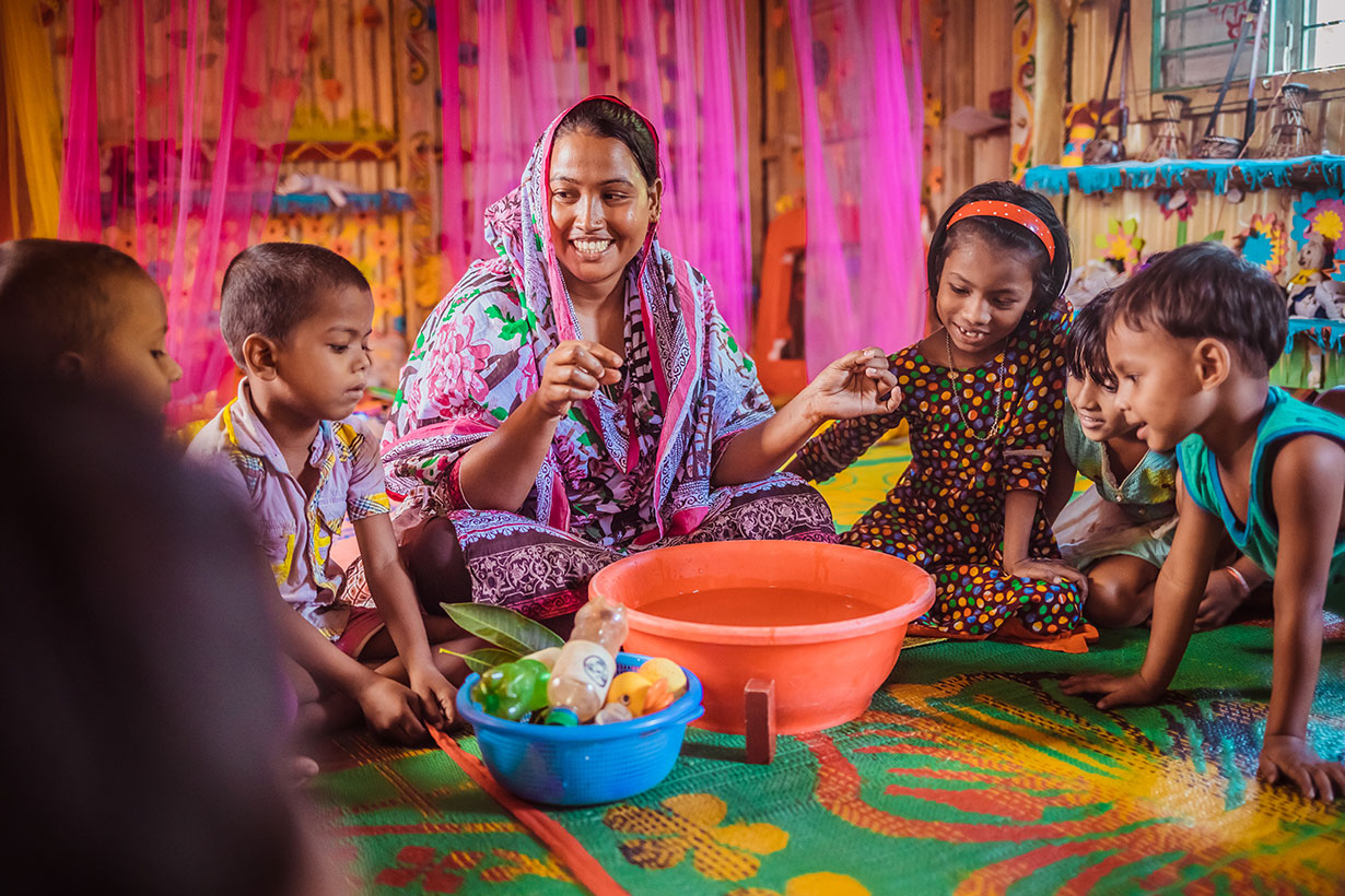 A Play Leader facilitates make believe play with children in a Play Lab in Bangladesh