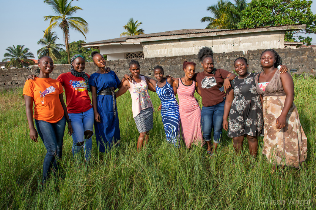 Josephine poses in a field outside her local BRAC girls clubhouse alongside several other young women who learned vocational skills through BRAC's youth empowerment program. Photo by Alison Wright.