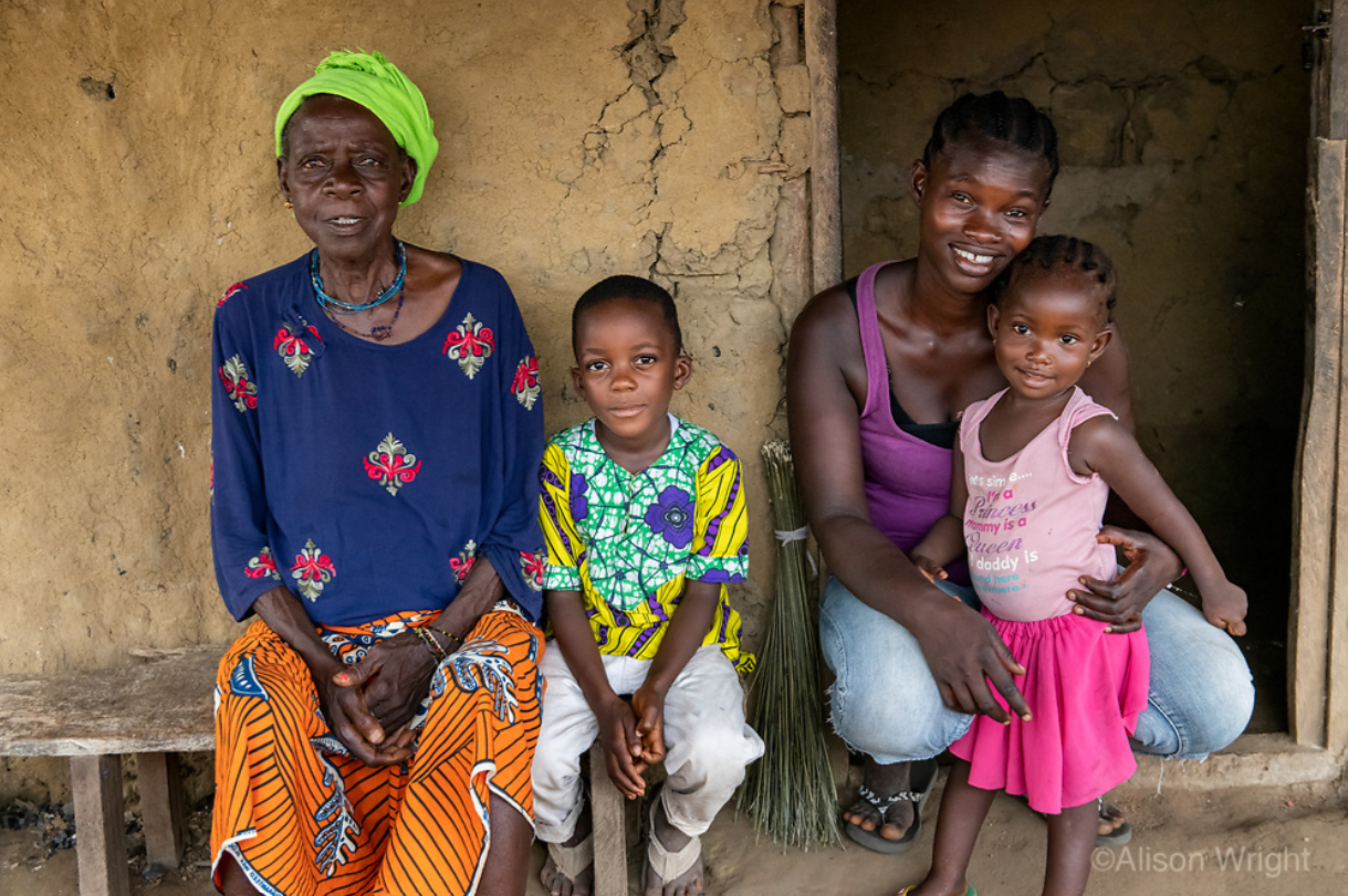 From left: Patience's grandmother, son, Patience, and her daughter pose outside their family home