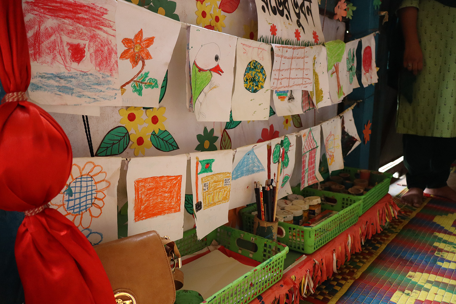 The painting and coloring corner in a Play Lab in Dhaka boasts a display of colorful art made by children.