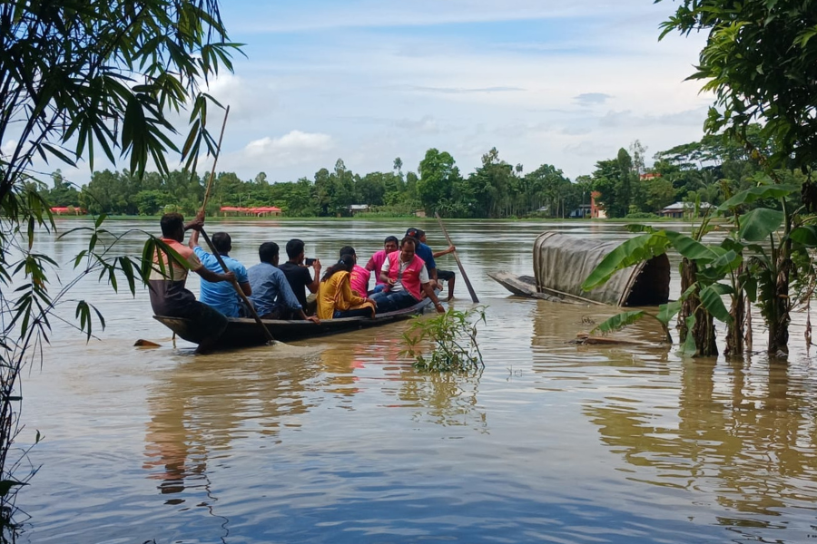 August 25, 2024: In Sreemangal Upazila, within the Moulvibazar district of Bangladesh, a team of BRAC staff travel by row boat to reach families in need of aid. BRAC teams are traveling by boats, tractors, and trucks to reach people who need the most help, wading door-to-door or floating rooftop-to-rooftop to deliver support.