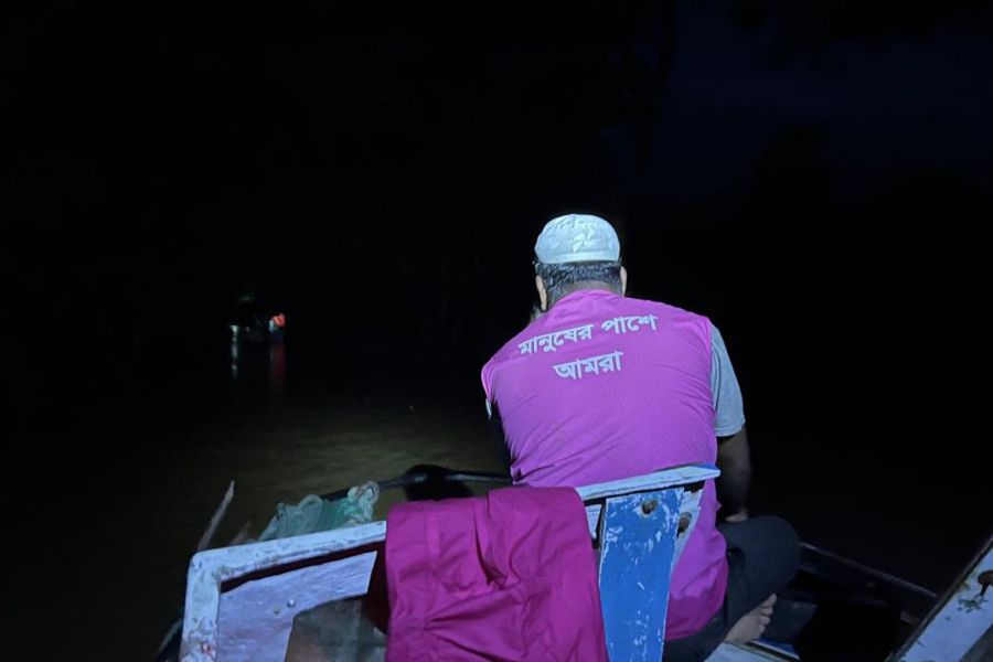 August 23, 2024: A BRAC staff member travels by boat after dark to reach families affected by flooding. During emergencies like this one, BRAC teams work around the clock to deliver aid to families in need: ensuring that they can reach as many families as possible with lifesaving support.