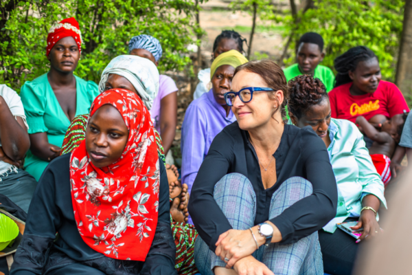 Julia Roberts, BRAC USA CEO, sits on the ground among a group of women meeting for a BRAC program in Uganda.