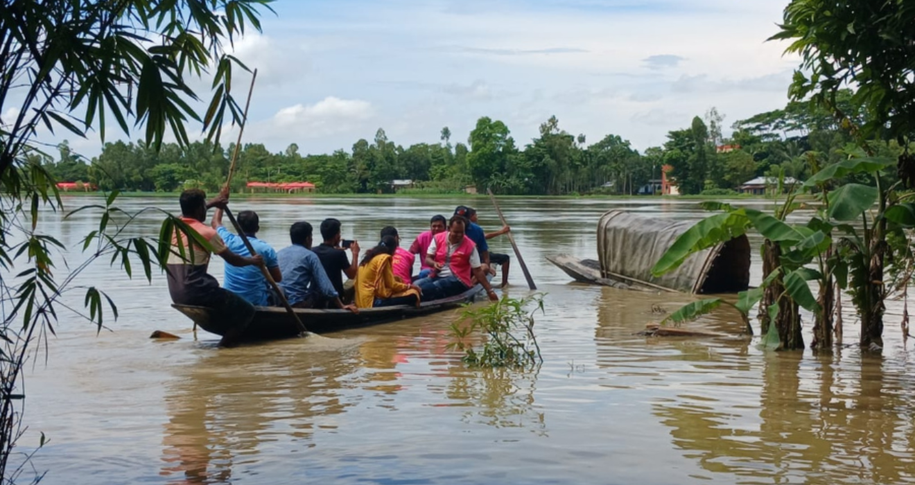 A BRAC team reaches impacted families by boat during the flood emergency.