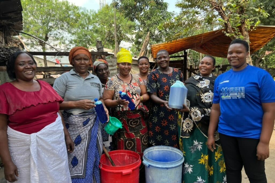 Mary stands alonside other women in her community