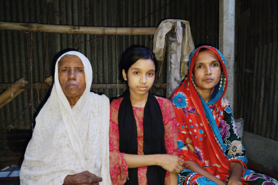 Najira, right, poses with two other women.