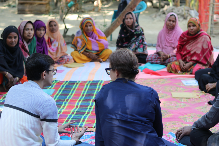 Julia Roberts, CEO of BRAC USA, sits in a circle with a group of participants and a staff member from an Ultra-Poor Graduation program in Bangladesh.