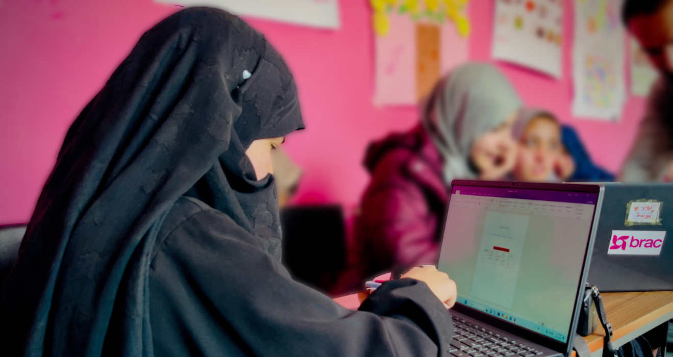 A girl in a BRAC learning program in Afghanistan works on a computer.