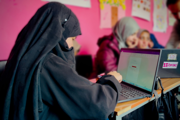 A girl in a BRAC learning program in Afghanistan works on a computer.