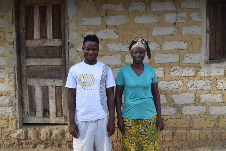 Standing in front of her home, Mamie poses with her son Michelle, who informed me that he has graduated from high school and is looking to start a charcoal business.