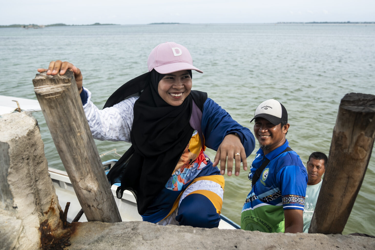 Darwina S. Tusay, AKAP Learning Facilitator for Grade 1, climbs the stairs after riding a speedboat in Tawi-Tawi, Bangsamoro Autonomous Region in Muslim Mindanao (BARMM), Philippines, on October 22, 2024. Photo by Lisa Marie David